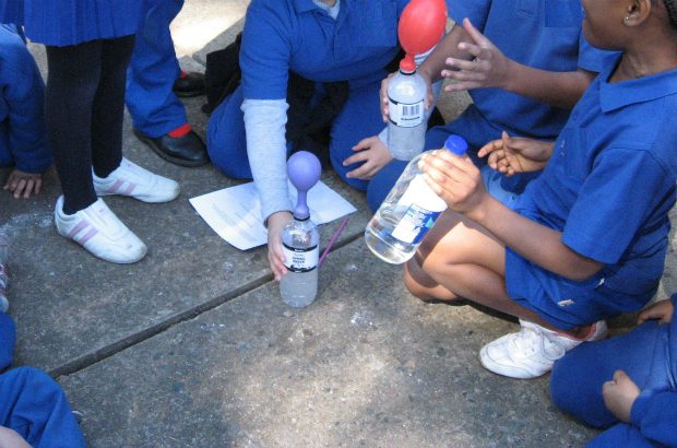 School children conducting science experiment