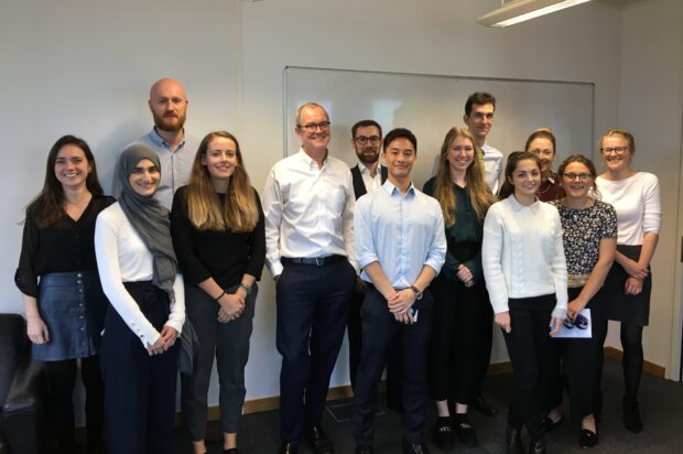 Sir Patrick Vallance poses for a group photo with interns.