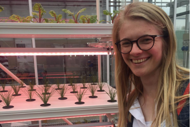 Kate in front of vertical crops at Nottingham Trent University vertical farming facility.