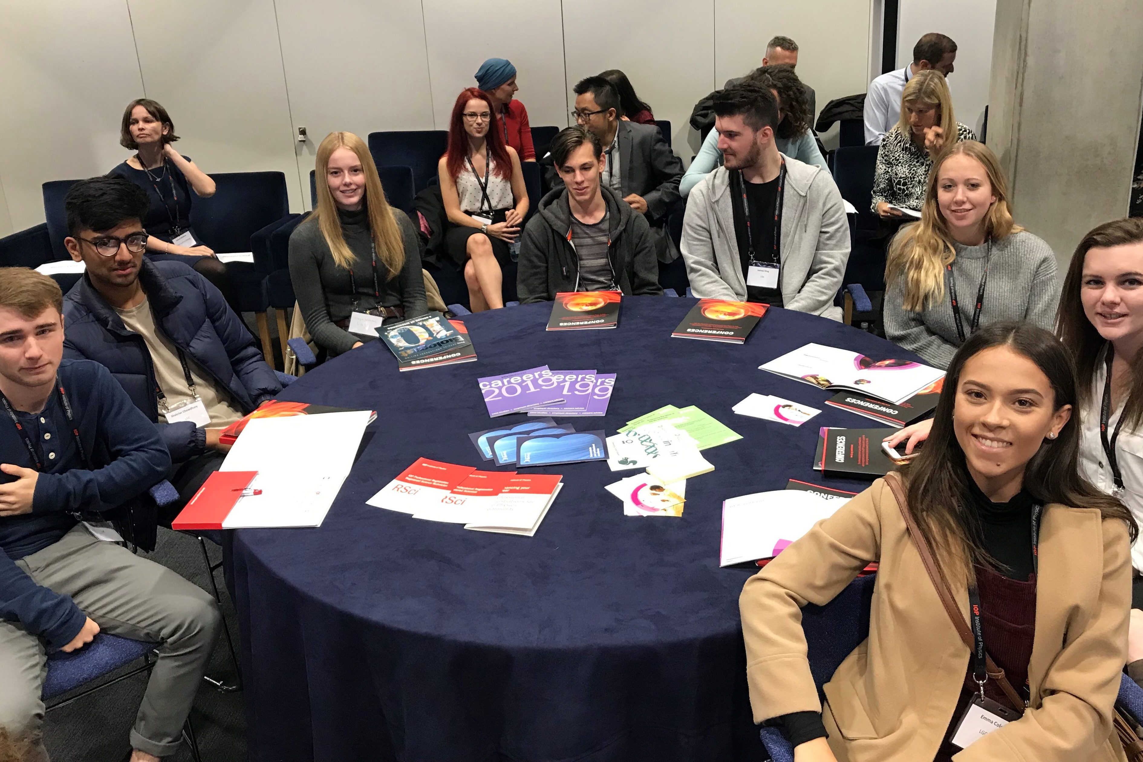 Group of apprentices sitting around a table.