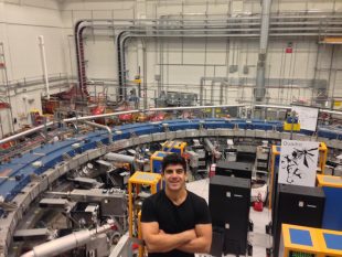 Dr Alex Keshavarzi next to the muon g-2 ring in the Fermilab.