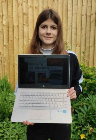 Amy Greener Showing her project on her laptop